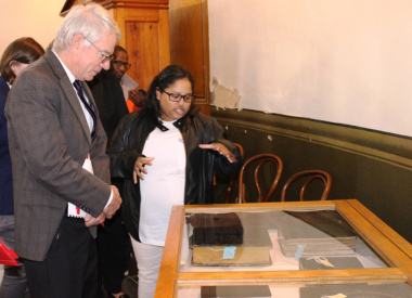 EPWP Intern, Lucretia Petersen at SA Sendinggestig Museum explaining to Minister Cronin about documenting the museum artefacts.