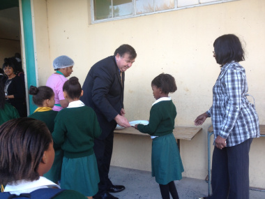 Mr Donald Grant sharing porridge with learners