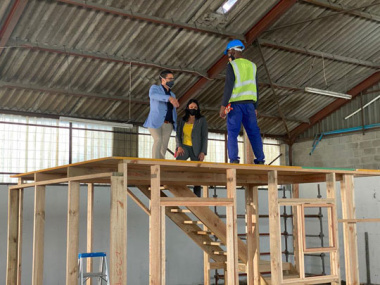 Western Cape Minister of Human Settlements, Tertuis Simmers and Head of Department, Jacqueline Samson on top of structure with one of the participants