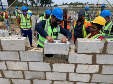 Front L – R: Western Cape Minister of Human Settlements, Tertuis Simmers and one of the women-owned sub-contractors, Ms Phumla Lombo, of Khollie & Sons Enterprise (SMME)