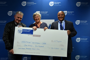 HWC Chris Snelling and Chairperson Antonia Malan receive the HWC payment from Guy Redman