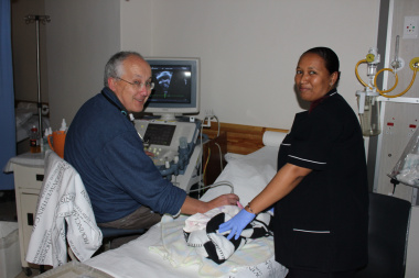 Dr John Lawrenson looks at a baby's heart. With him is Sr Alloise Schoeman.