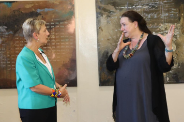 Jeanette explaining the intricacies of the paintings to Minister Marais.