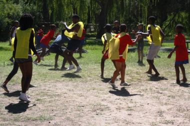 Learners playing the indigenous Game of “Drie Blikkies”