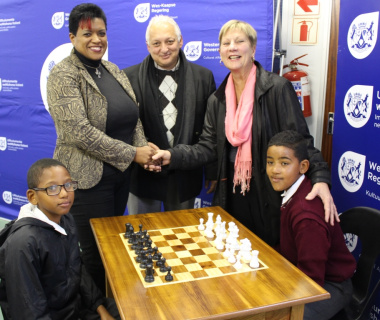 Mercia Sias and Cecil Cupido receiving the chess tables from Minister Anroux Marais.