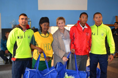 Minister Anroux Marais (centre) with the coaches and learners from some of the schools who received kits