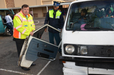 Minister Grant and Principal Inspector Louw from the City of Cape Town's Traffic Services with the door that fell off a scholar transport vehicle.