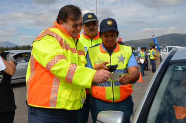 Minister Grant Chief Africa and a traffic officer with the new hand-held device.