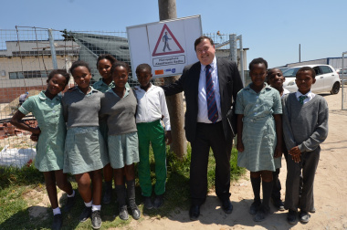 Minister Grant with Itsitsa Primary School learners during the unveiling of the Child Pedestrian Safety posters.