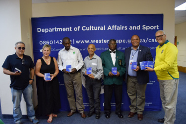 Minister Marais and HOD Guy Redman handing the booklet over to stakeholders from Boxing in the province.