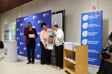   Minister Anroux Marais handing over an oral history poster to one of the library managers at the launch in Worcester