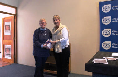 Minister Marais hands DVDs over to Francis van Wyk from Laingsburg Flood Museum.