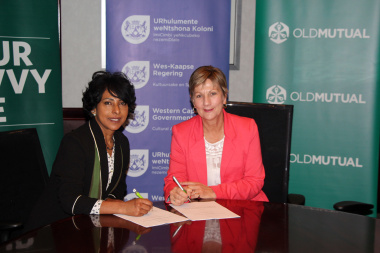 Minister Marais signs the agreement with Helene Africa from Old Mutual