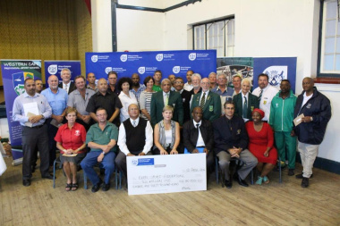 Minister Marais with other DCAS officials and the recipients of the cheq...