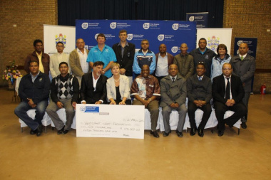 Minister Marais with other DCAS officials and the recipients of the cheque of R615 000