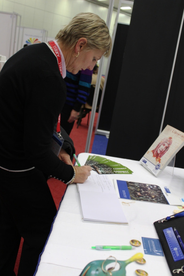Minister signing the visitors’ book at the Western Cape Library Services Exhibition Stand.
