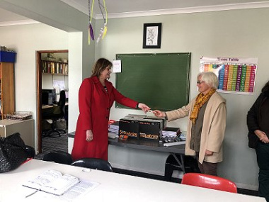 Minister Schafer hands over stationery to the Director of Ons Plek Girls Shelter, Pam Jackson