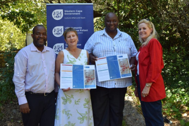 Mxolisi Dlamuka, Minister Marais, Prof Mawande Diali and Anita van der Merwe proudly presenting the Khoekhoe geographical names brochure