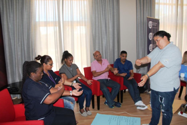 Nurses and physiotherapists learning how to sign some common phrases to assist them with communicating with Deaf patients