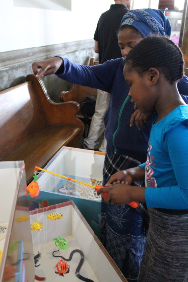 One of the learners shows her friend how to play fish