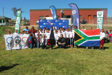 Participants light the Olympic torch in Van Wyksdorp