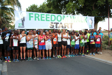 Participants of the 27km race singing the national anthem