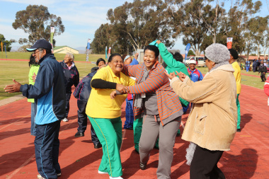 Participants take part in an impromptu dance to warm up for the games.