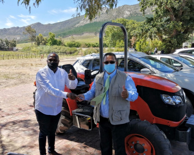Paul Siguqa receives the keys to a new tractor from Minister Meyer