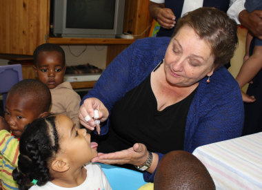 Dr Helise Schumann administers polio drops.