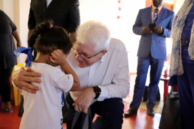 Premier Alan Winde hands over a gift to one of the children who attends Rocklands Educare creche in Mitchells Plain.
