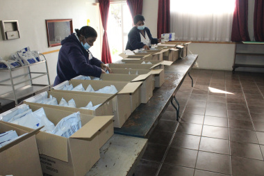 Prepacked medication parcels being sorted at an offsite collection point