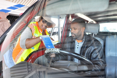 Road safety officer Nonkosi Peter speaks to taxi driver Xolani Tiwayi.