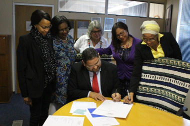 Signing of the pledge by HOD Brent Walters and female SMS members