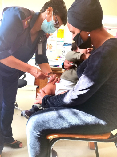 Sister Michele Ambrose immunises nine-month-old Aden George at the Bishop Lavis Community Health Centre.