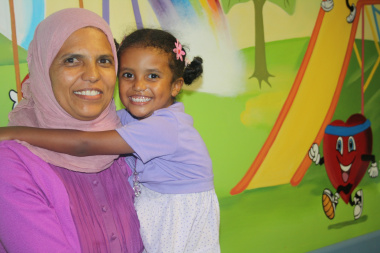 Thaakirah Matthews, with her mother Raadhiyah, in front of the mural that her family donated to Red Cross War Memorial Children’s Hospital.  