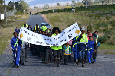Learners and officials spread road safety awareness.