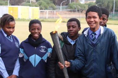 The symbolic torch reminds learners about the Olympic values