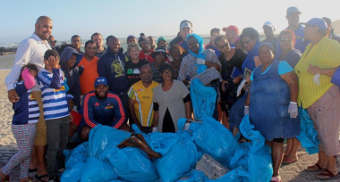 The team with the many bags of litter they collected from the beach.