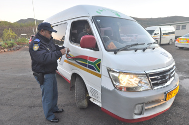 Traffic Officer Marco Arries inspects a minibus taxi.