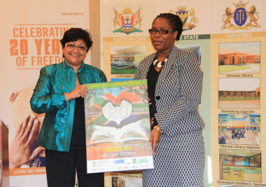 Ujala Satgoor (LIASA President) hands over a SALW poster to DCAS Director for Library Services Nomaza Dingayo.