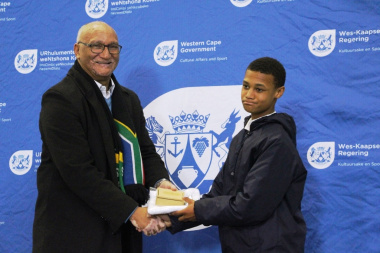 Under-13 long jump champion Jean-Pierre Snell being awarded for his achievements