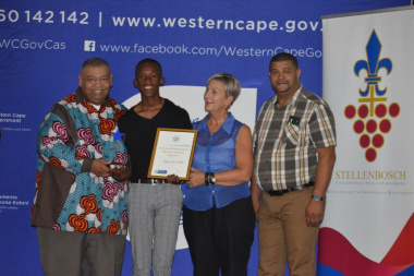 Vuyolwethu Tanga (second left) receives the Best Actor award from Minister Anroux Marais