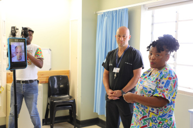 Minister Dr Nomafrench Mbombo being briefed on the TeleICU project by Dr Nellis van Zyl-Smit, the Medical Manager of George Regional Hospital, and Dr Ivan Joubert who joined virtually through the Double Robotic Device.