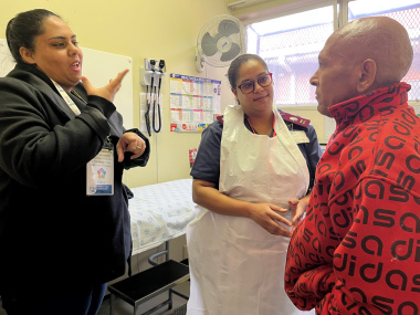 Sign language interpreter, Ashlene Dammert, signs to patient Lawrence Alberts what Sr Germaine Faro explains to him.