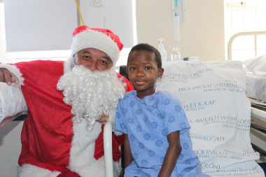 Sibonile Sibulele receiving a gift from Father Christmas. 