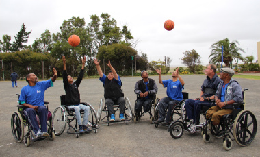 Wheelchair basketball athletes show their excitement on the court.