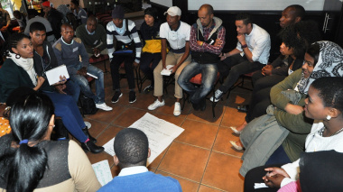 Young people actively debating road safety issues and possible solutions.