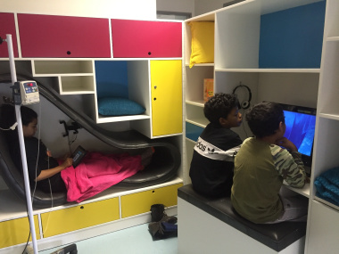 Brothers, Rameez (right) and Rafieq, watch a movie while Zyaan relaxes in the pod while receiving treatment.