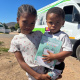Marilynn Adams (7) and Misokuhle Gertse (18 months) visited the mobile clinic with their caregivers to access healthcare.