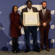 Head of Department (HOD), Adv Yashina Pillay; Centre: Director: Monitoring and Evaluation, Mr Bhekithemba Simelane receiving his 20-year service award, Right: Minister Reagen Allen